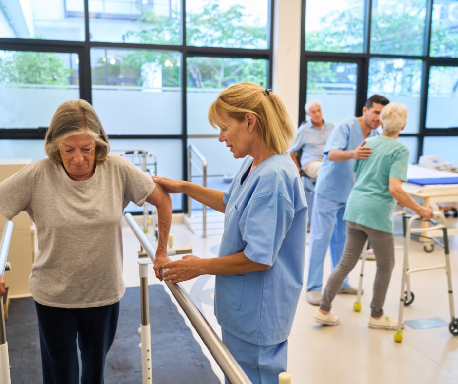A physiotherapist supporting a patient at the parallel bars