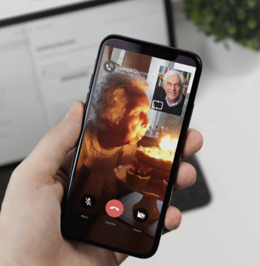 A family member on a video call with an older relative using the Companion App.